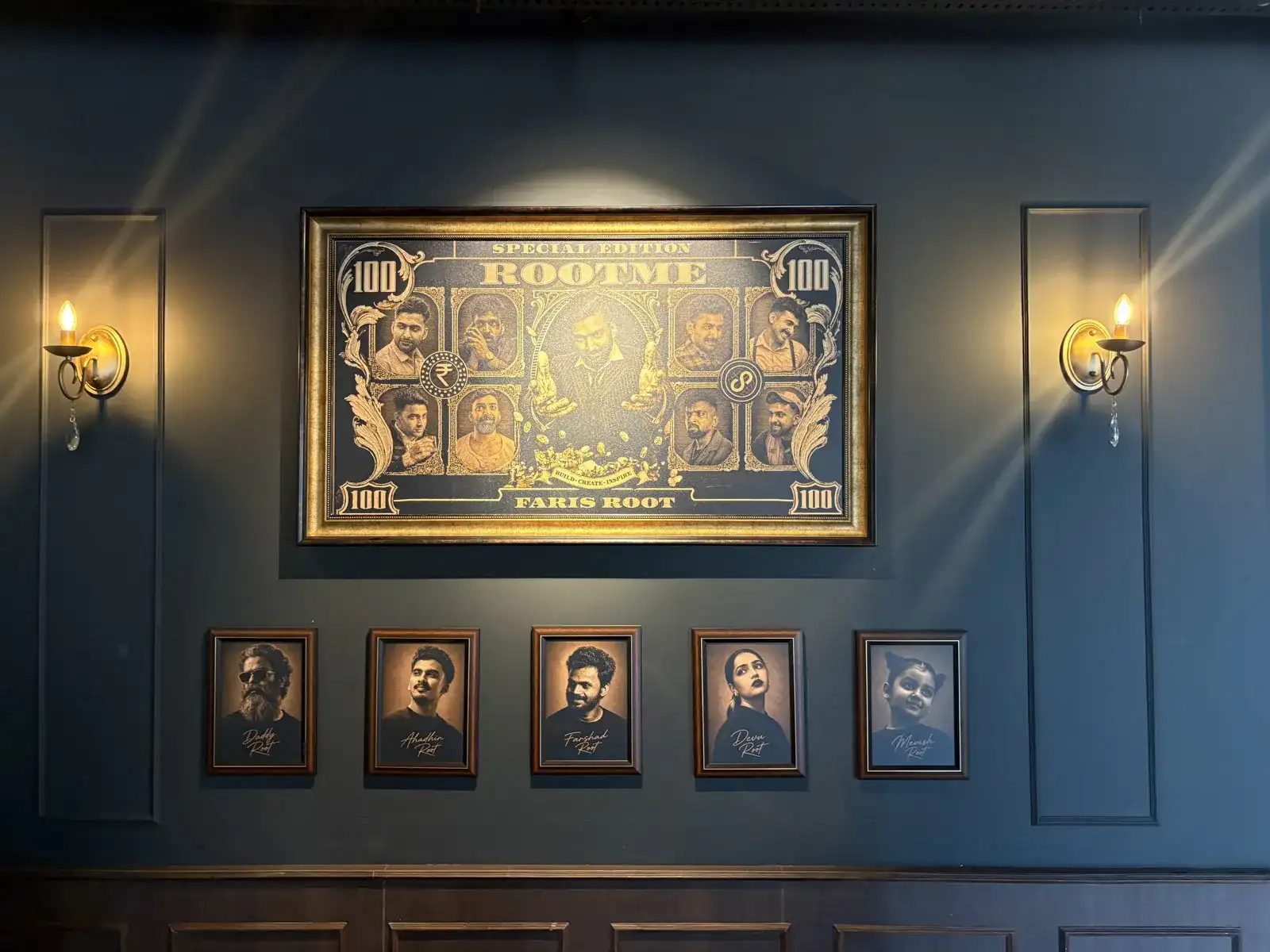The framed Rootme / Faris Root print and wall sconces in the Rootmedia lounge