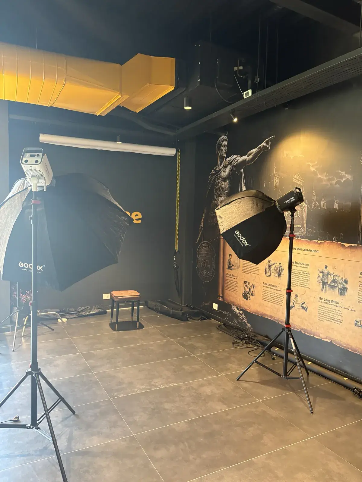 Softbox and umbrella lighting set up for a portrait shoot on the Rootmedia studio floor