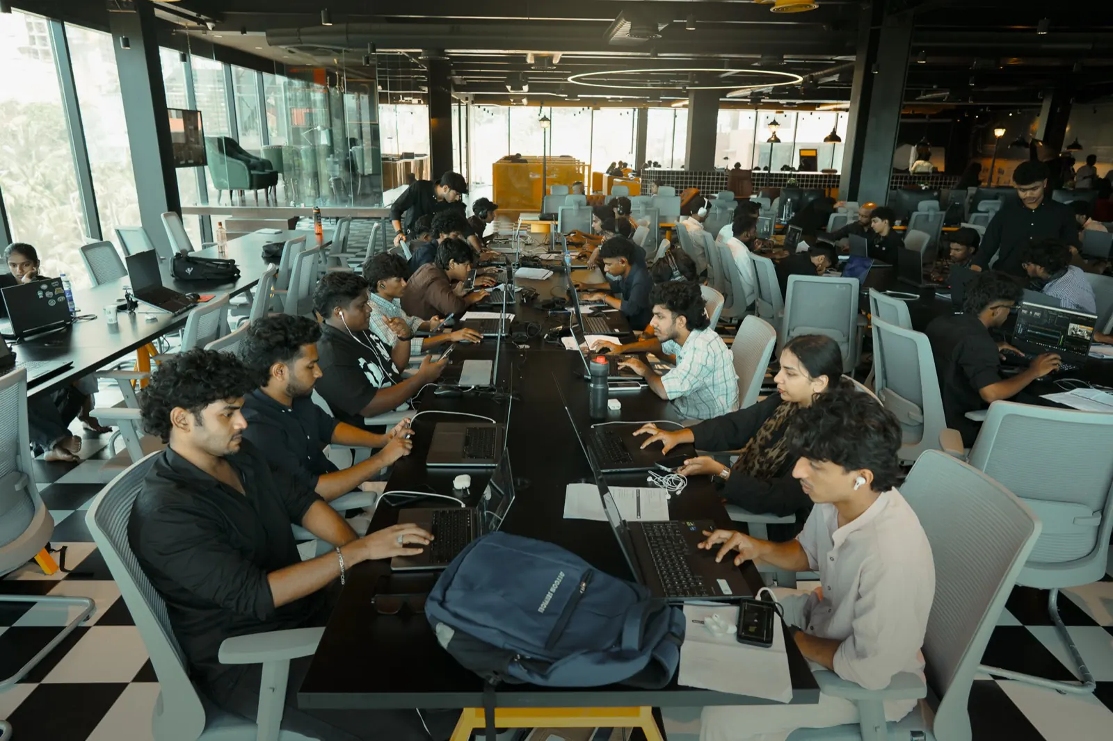 Students at laptops along a shared desk during a Rootmedia session