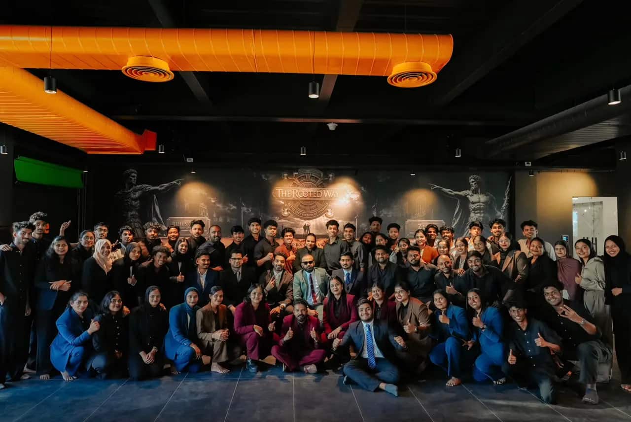The full Rootmedia batch photographed together in front of the Rooted Way mural in the Kozhikode labs