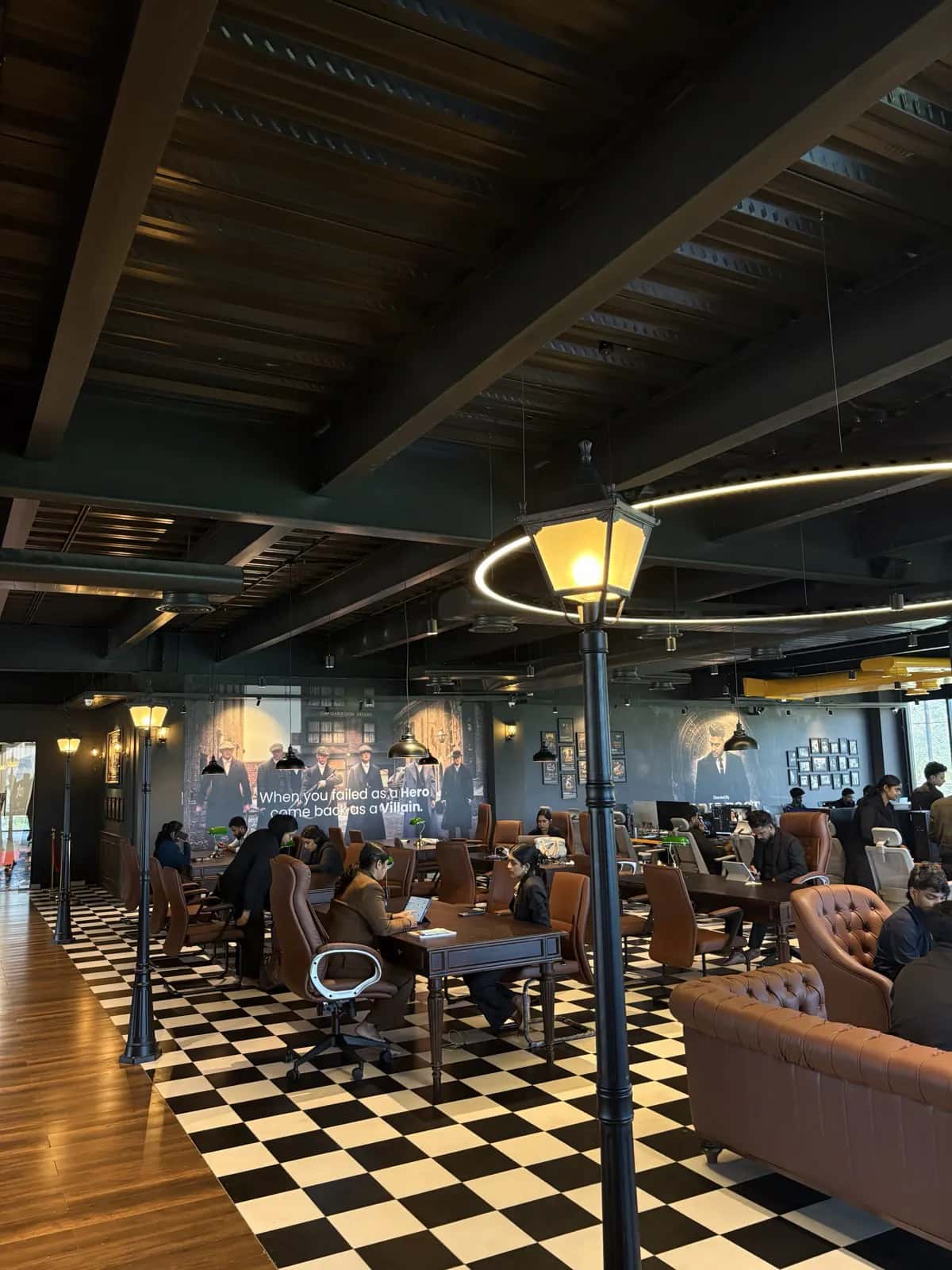The Rootmedia lounge — checkerboard floor, leather seating and pendant lighting