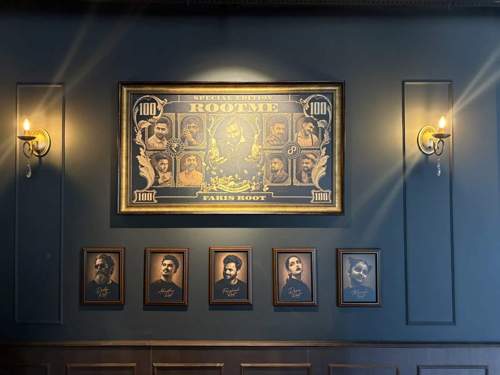 The framed Rootme / Faris Root print and wall sconces in the Rootmedia lounge